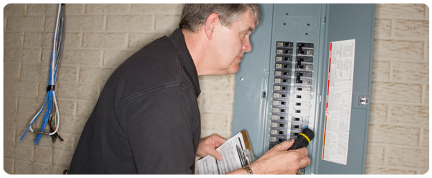 A photo of Attaboy giving a customer an electrical panel upgrade.
