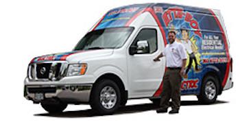 An electrician from Attaboy Services in Littleton, CO, standing next to our company van with the logo on the side.